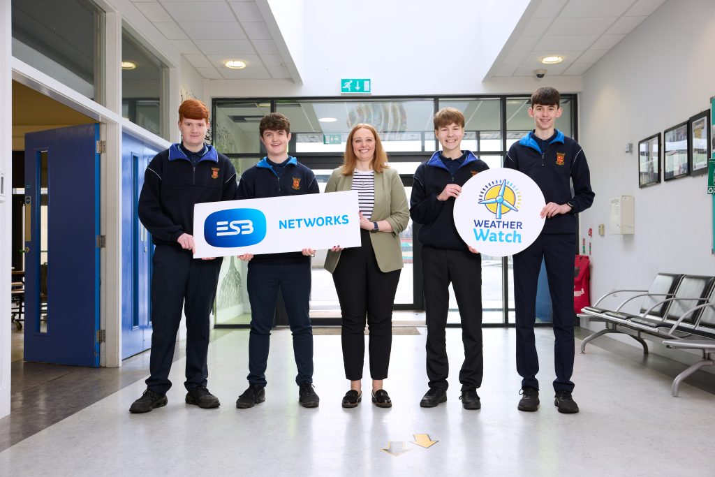 Group of students and teacher in school corridor with ESB Networks and Weather Watch programme banners.